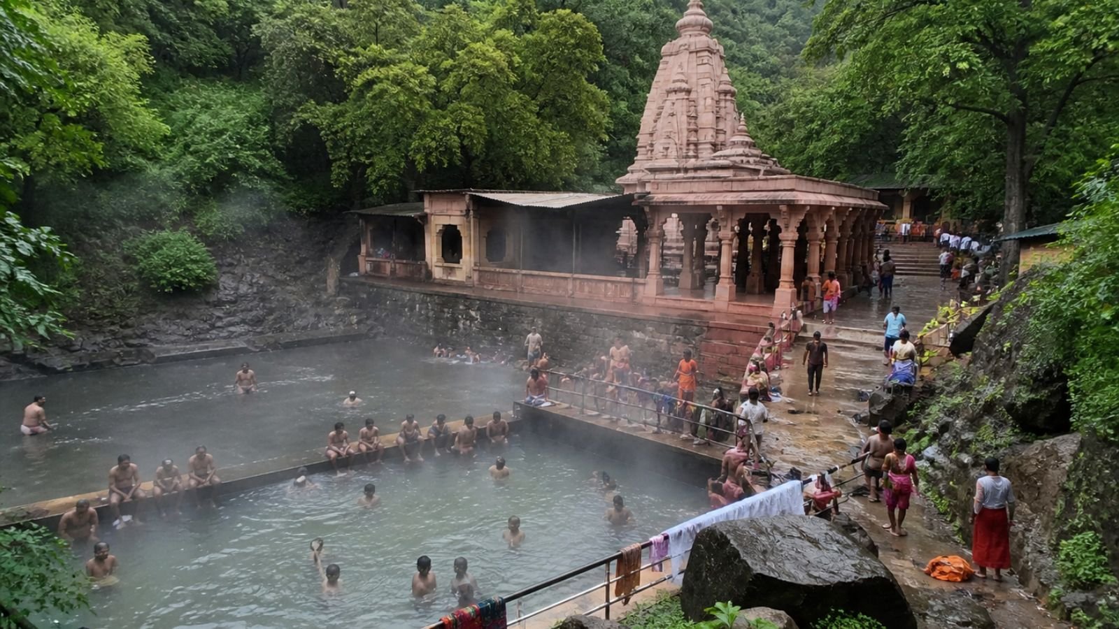 High-detail realistic image of Tulsishyam temple hot springs kund showing pilgrims bathing in steaming natural water pools with temple architecture and lush forest surroundings in Gujarat, no text, logos, or symbols (representative image).